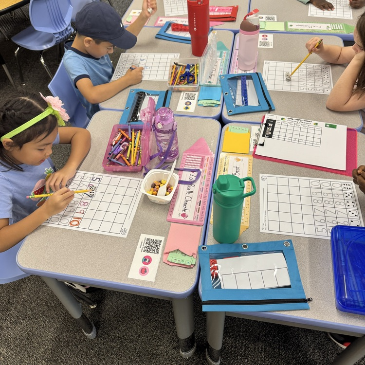 students writing numbers to tell the quantity