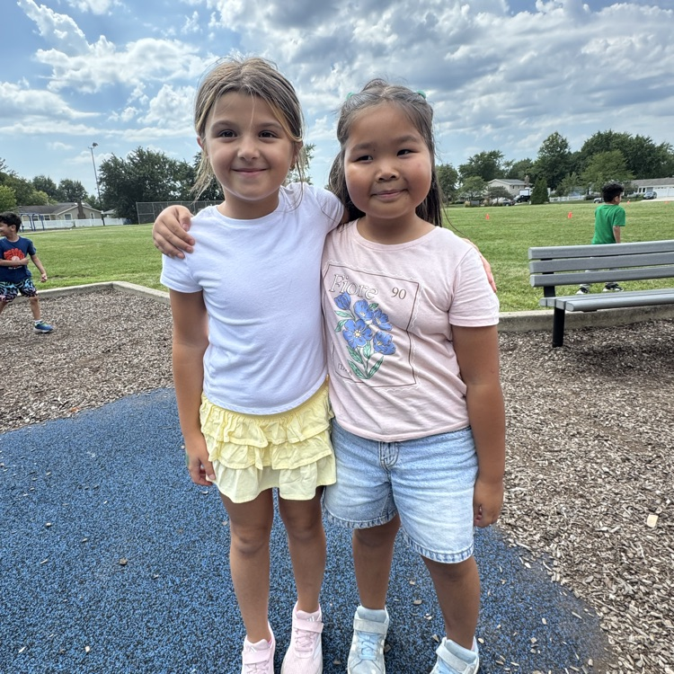 Two second graders smiling together