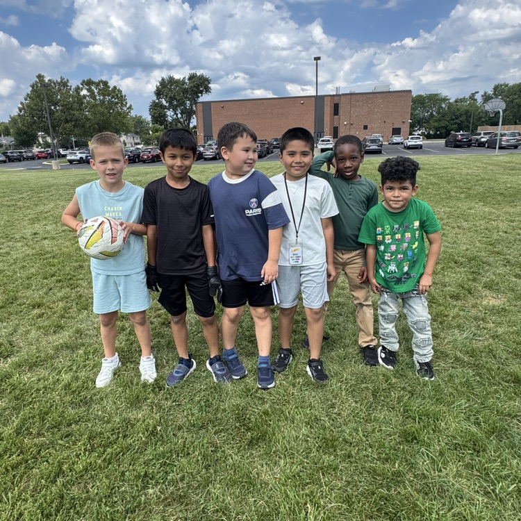 Group together smiling after playing soccer