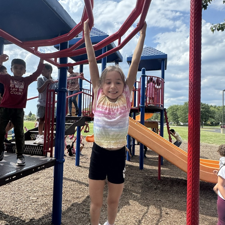 A 2nd grader on the monkey bars!