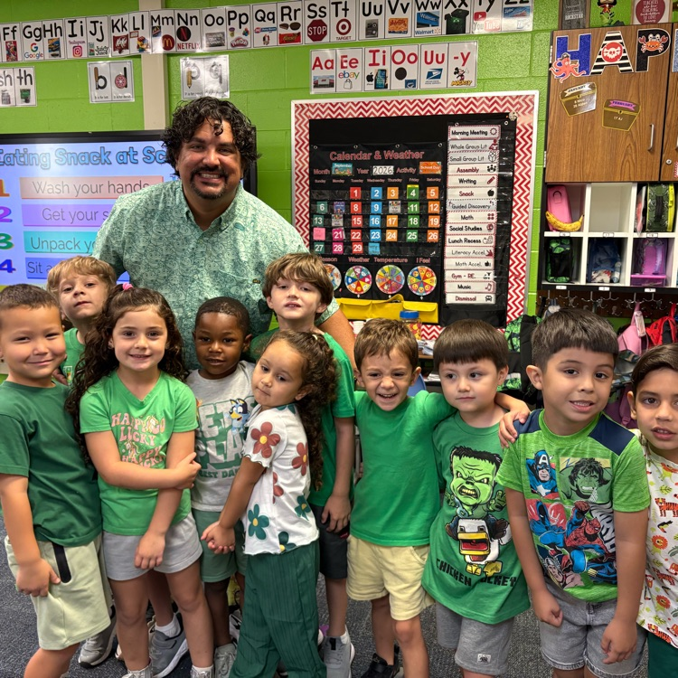 Teacher and students wearing green outfits.