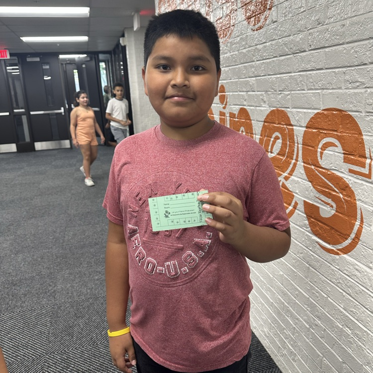 student holding a stamp card