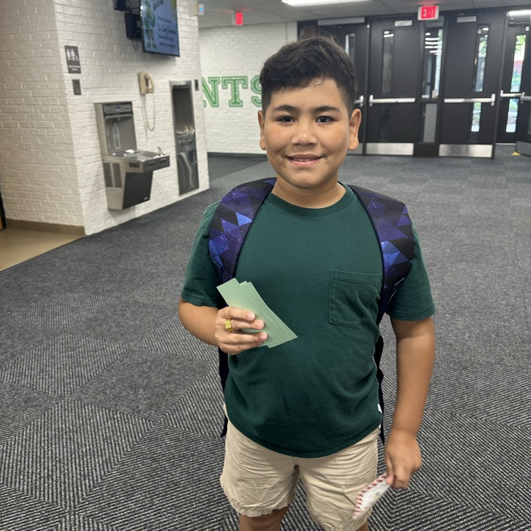 student holding a stamp card