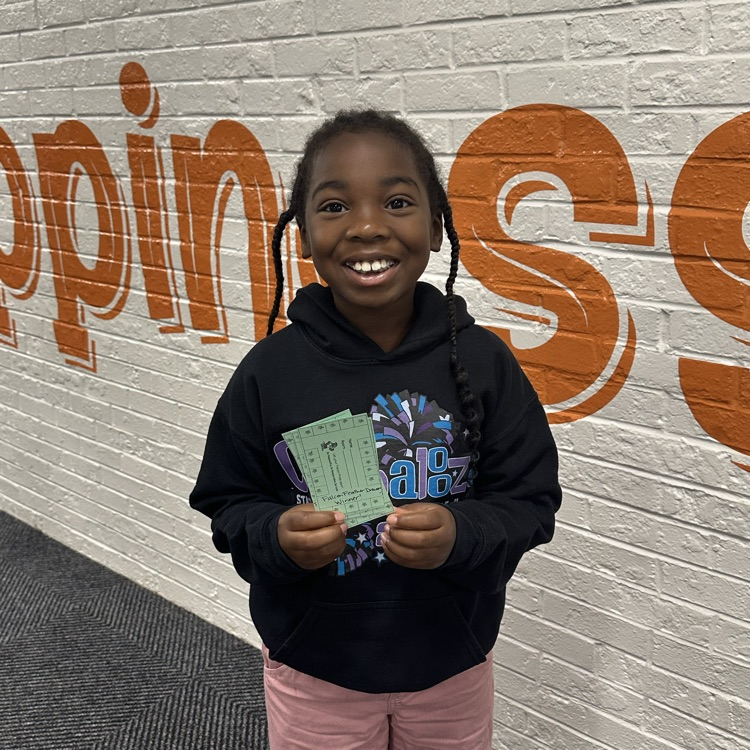 student holding a stamp card