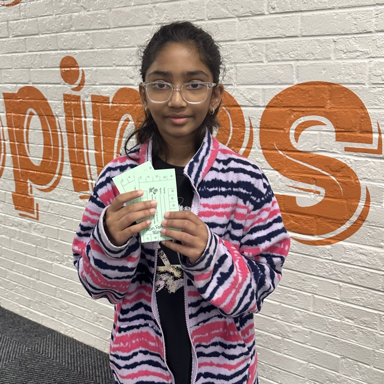 student holding a stamp card