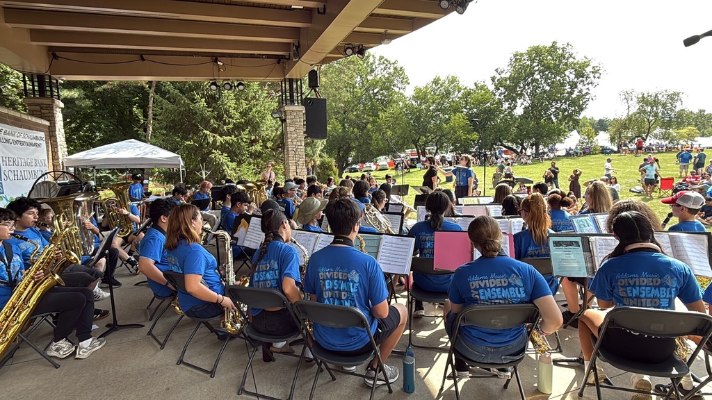 Band and Orchestra students playing their instruments at a festival