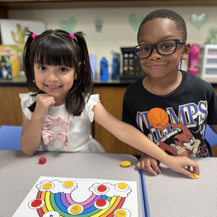 Kindergarten mathematicians posing with their game board
