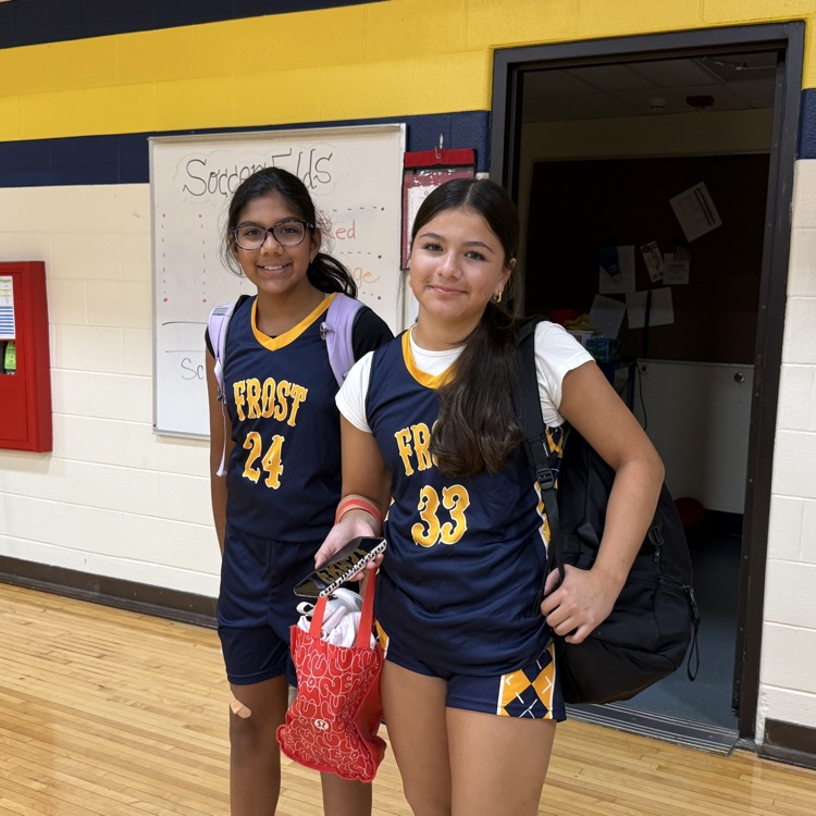 two girls in basketball uniforms
