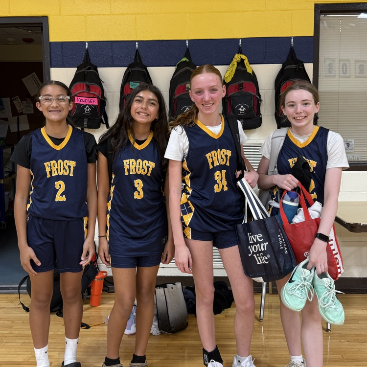 four girls in basketball uniforms