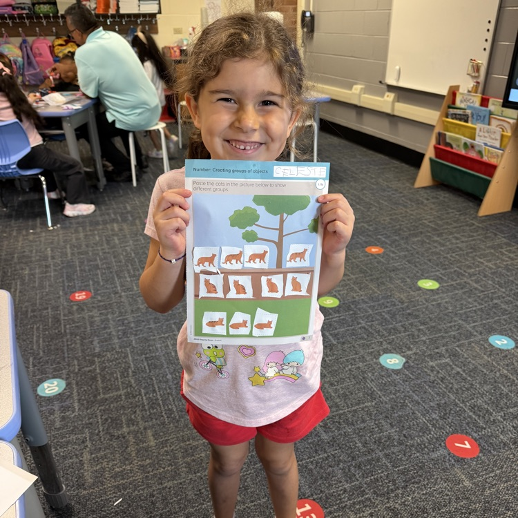 Kindergarten student and her journal page.