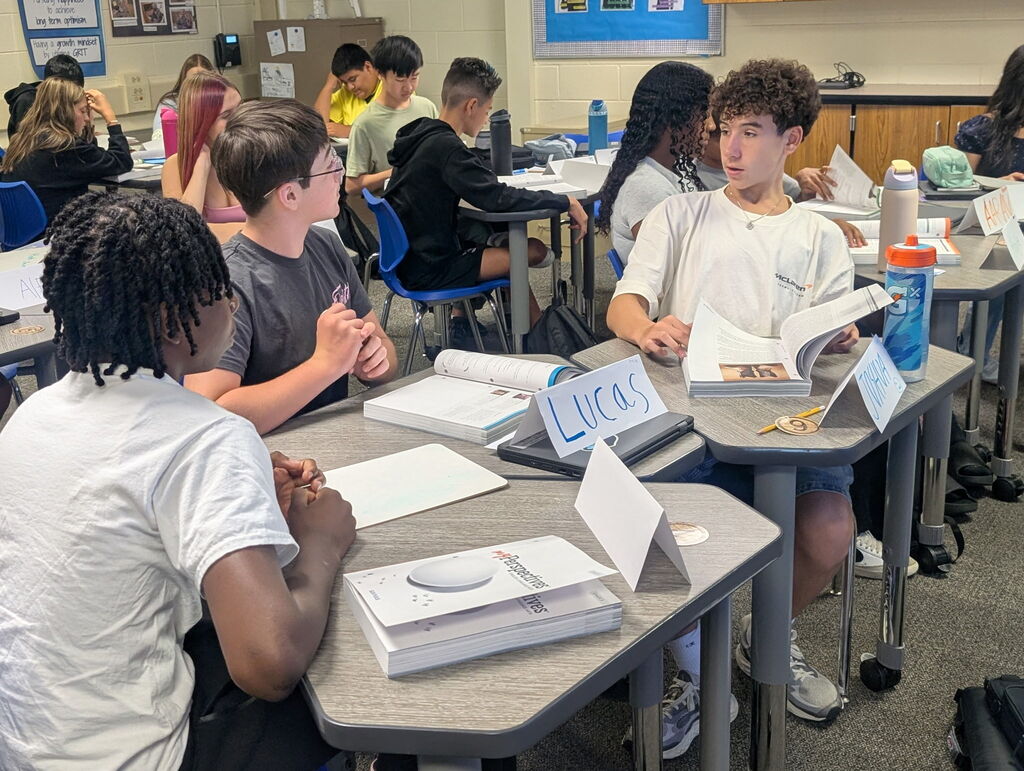 Students in a classroom collaborating on an assignment