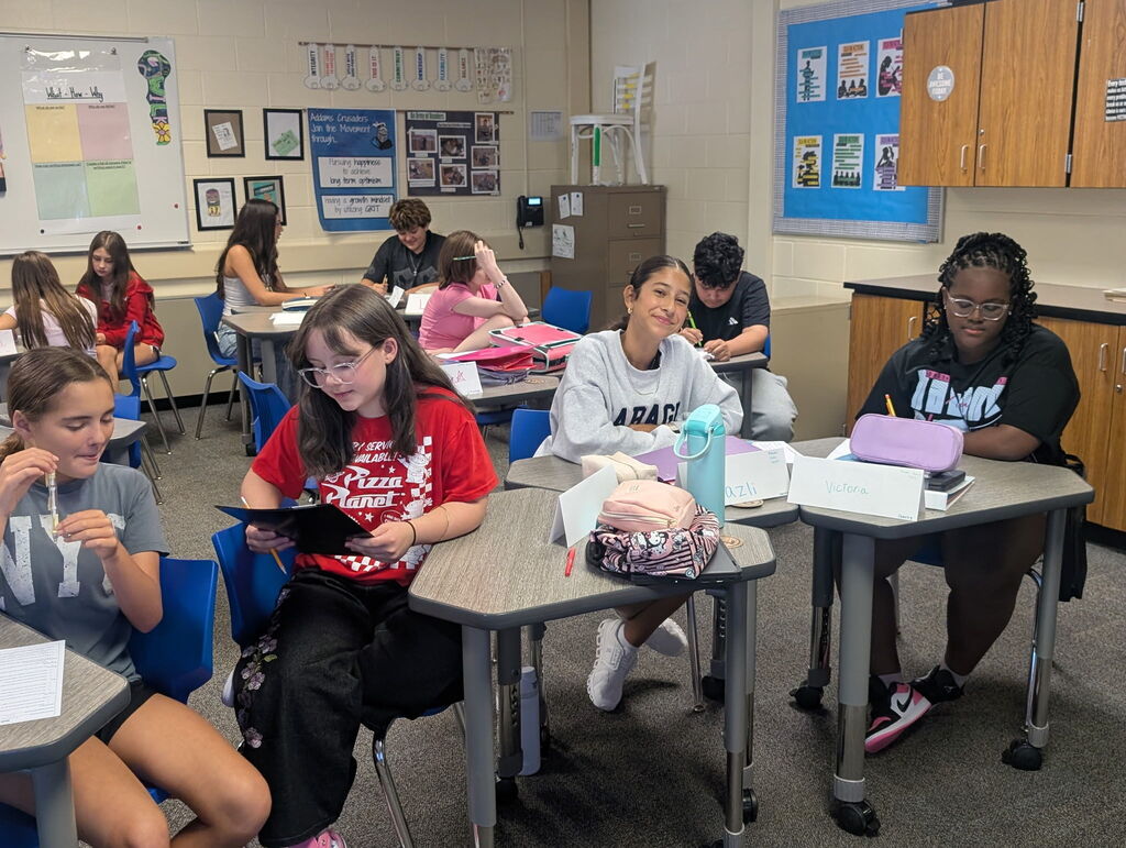 Students in a classroom collaborating on an assignment