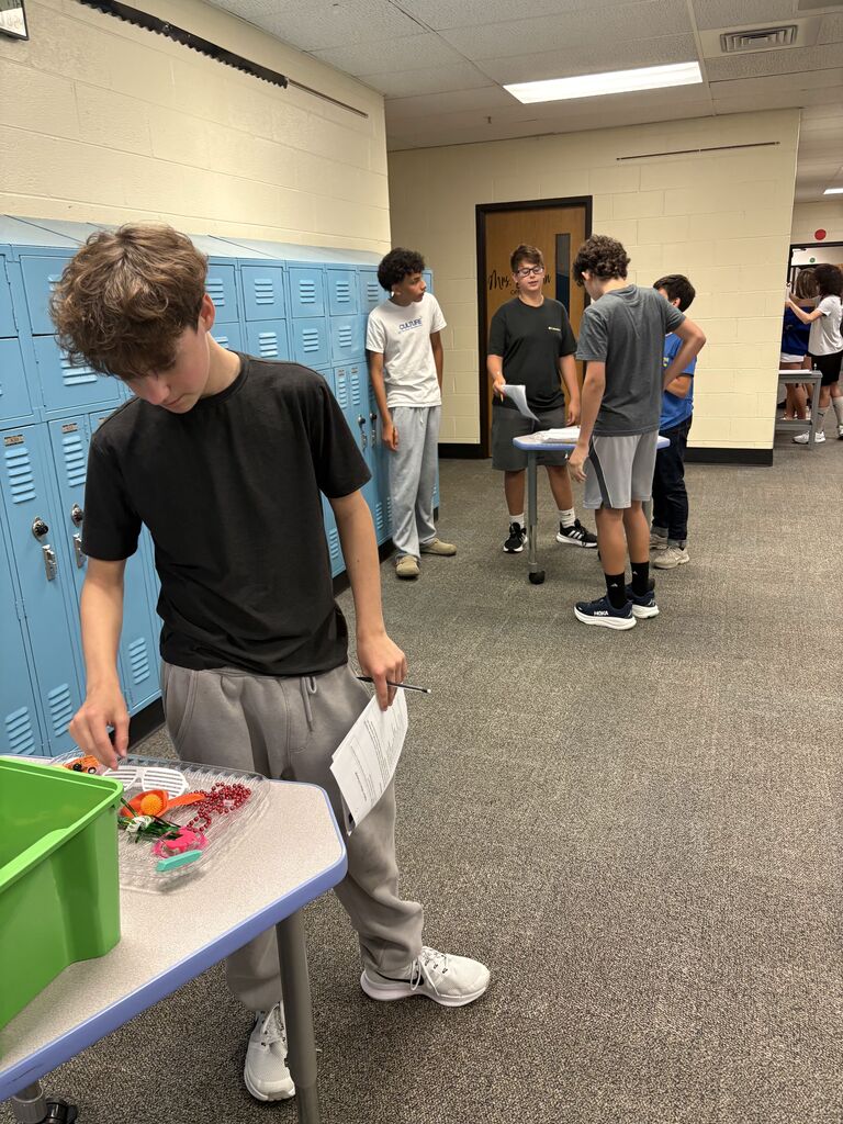 Students in a hallway collaborating on an assignment
