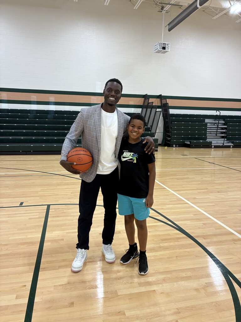 Motivational Speaker and student in gym with basketball