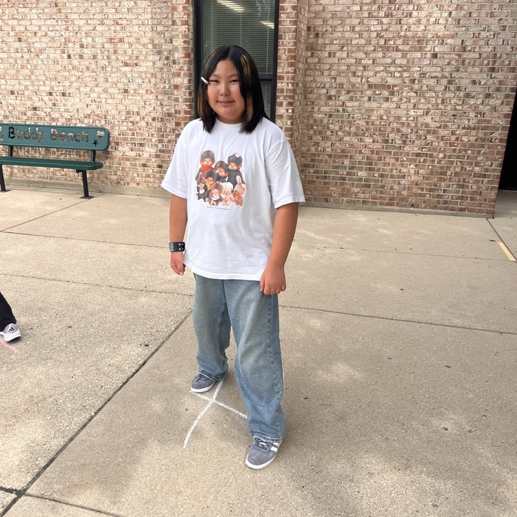 student standing on chalk lines on sidewalk