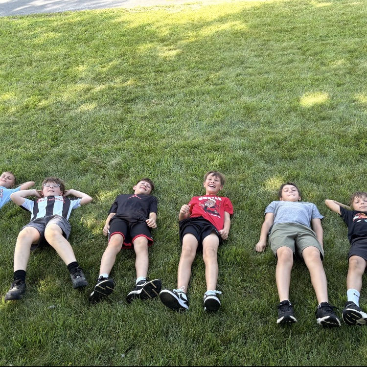 Group of 6th grade boys relaxing after a team building activity. 