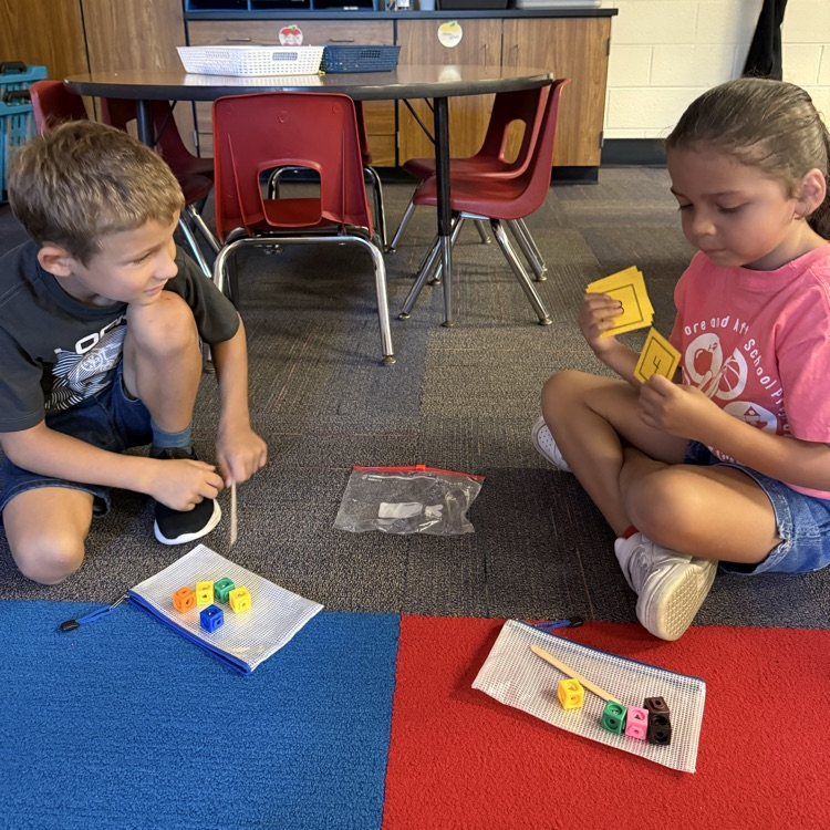 a boy and girl using cubes to count