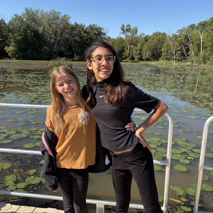 Two students in front of the pond.