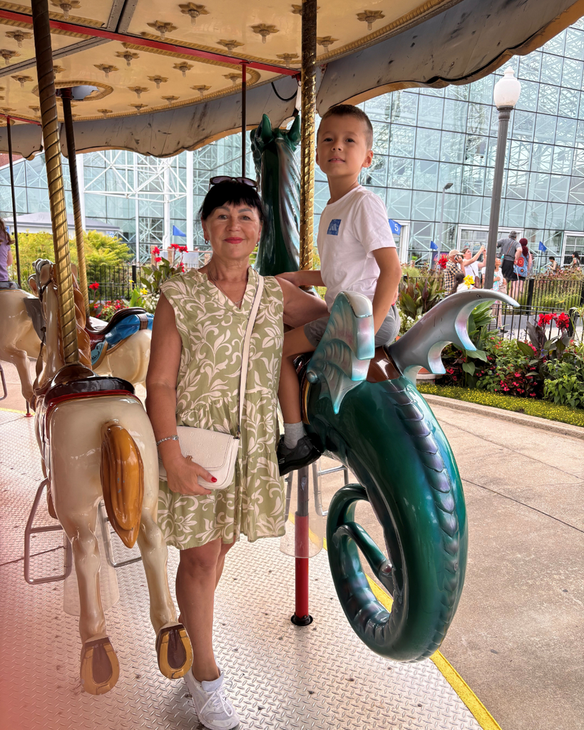 Grandma on a carousel with her grandson