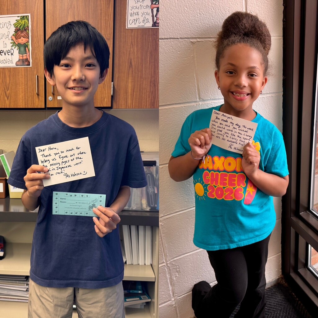 Two students holding postcards smiling