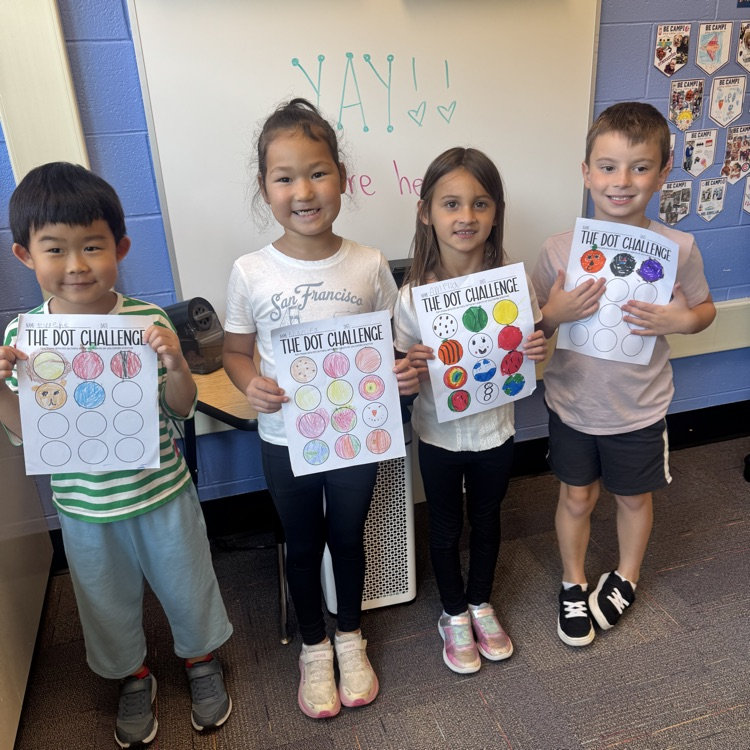 four students showing their Dot Day artwork 