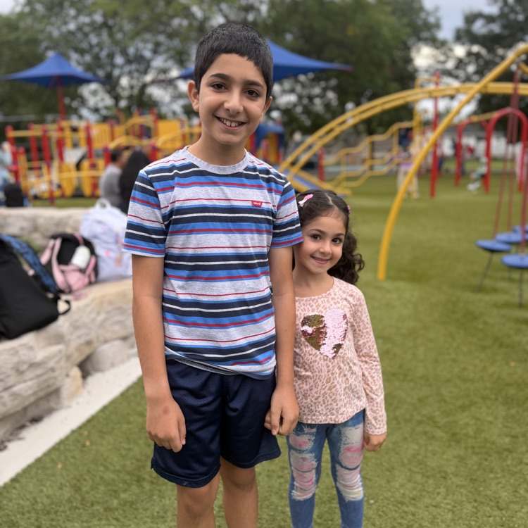 Student siblings outside on playground
