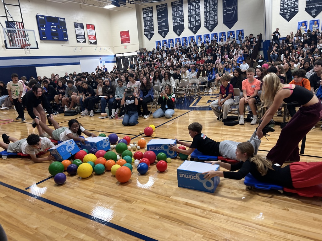Staff and students participating in a human hungry hungry hippos game
