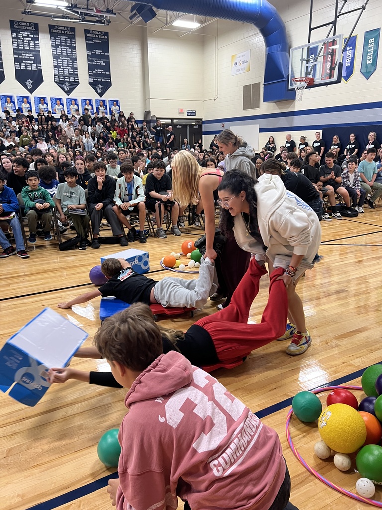 Staff and students participating in a human hungry hungry hippos game