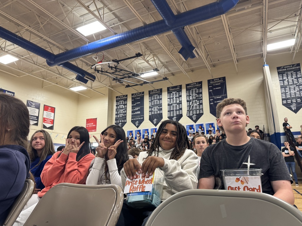students posing for a picture at an assembly