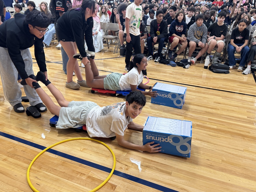 Staff and students participating in a human hungry hungry hippos game