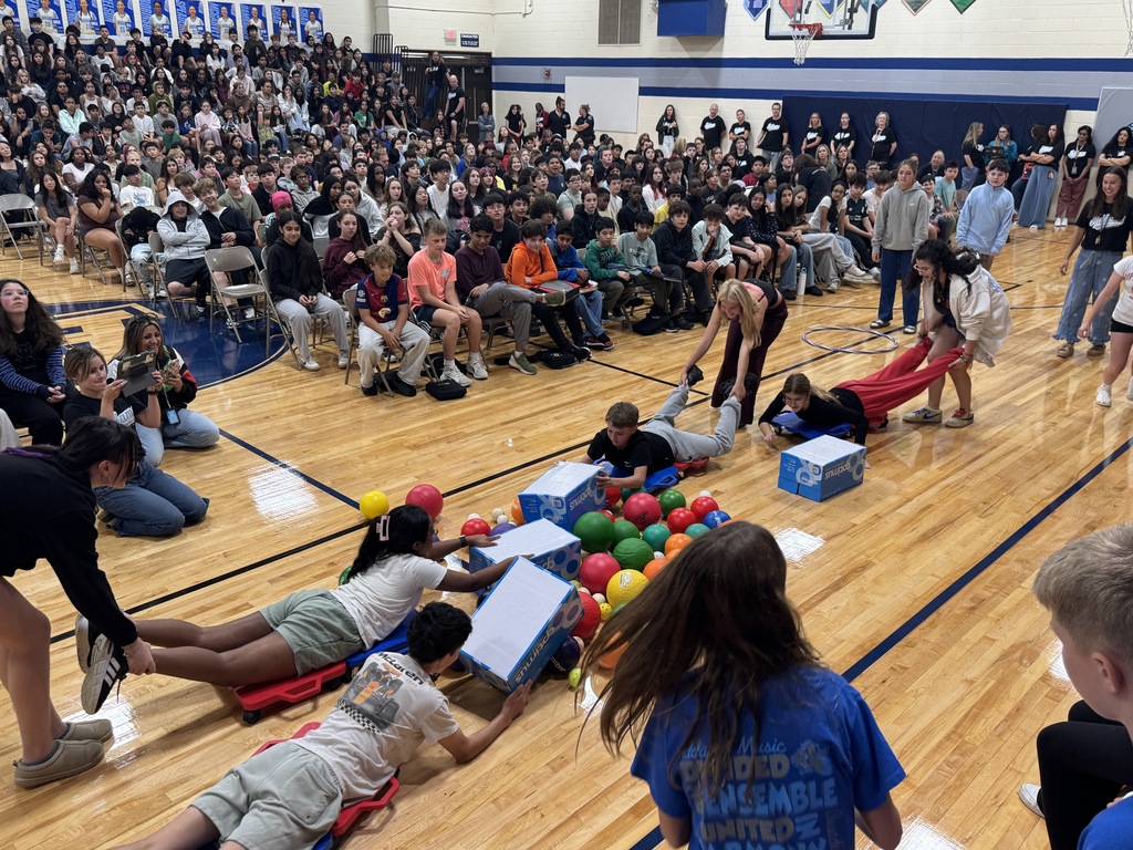 Staff and students participating in a human hungry hungry hippos game