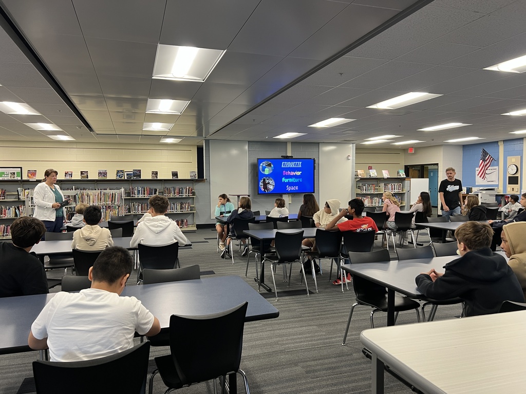 Students listening to a presentation about the library