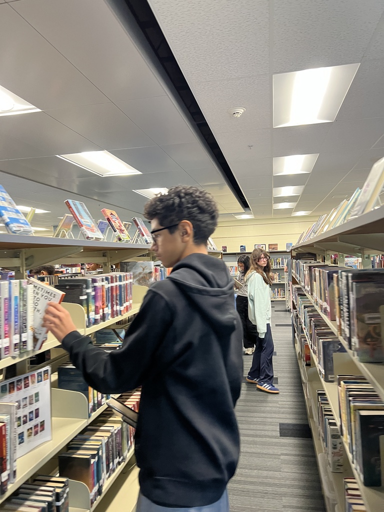 Students searching for books at the library