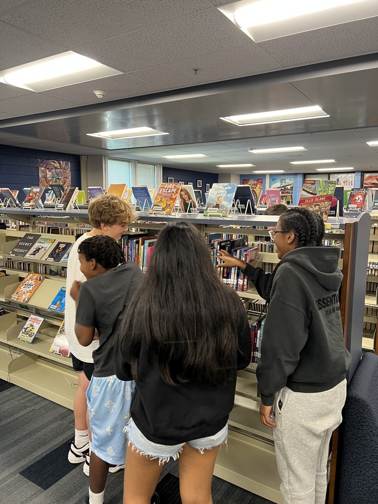 Students searching for books at the library