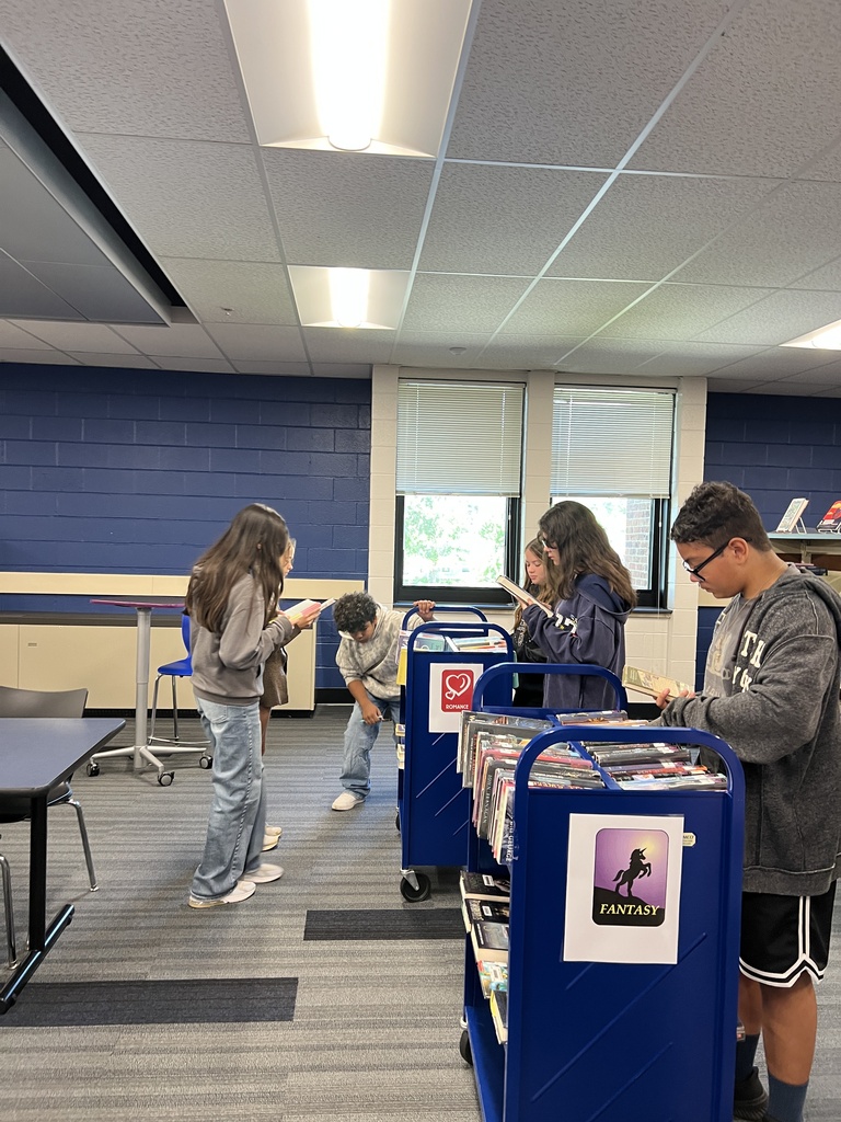 Students searching for books at the library