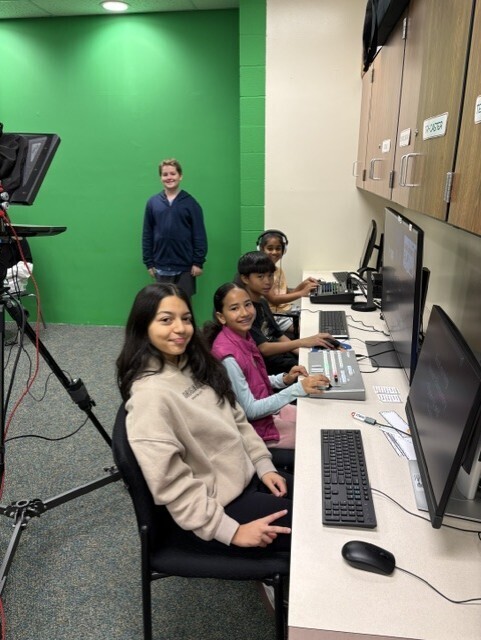 studio crew seated and working on live announcements