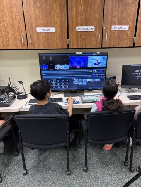 studio crew seated and working on live announcements