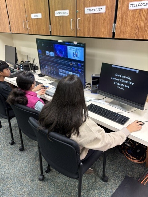 studio crew seated and working on live announcements