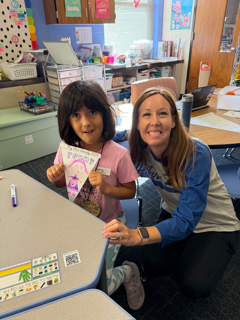 Mrs. List and a student working on their pennants