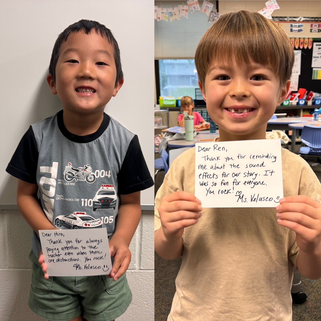 two boys holding postcards