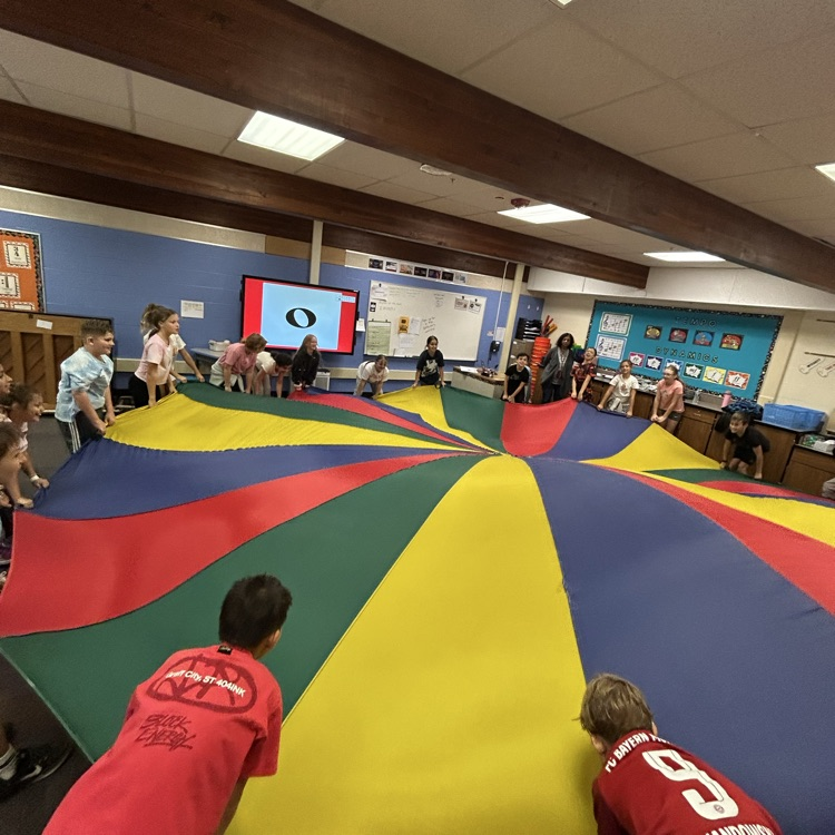students moving a parachute 