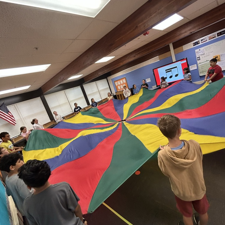 students moving a parachute 