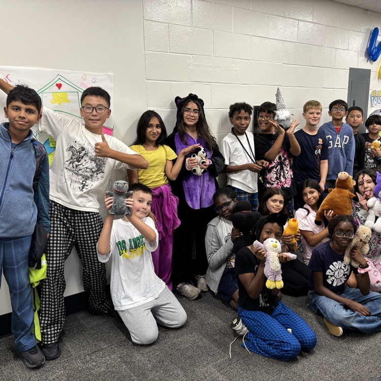students dressed in pjs holding stuffed animals