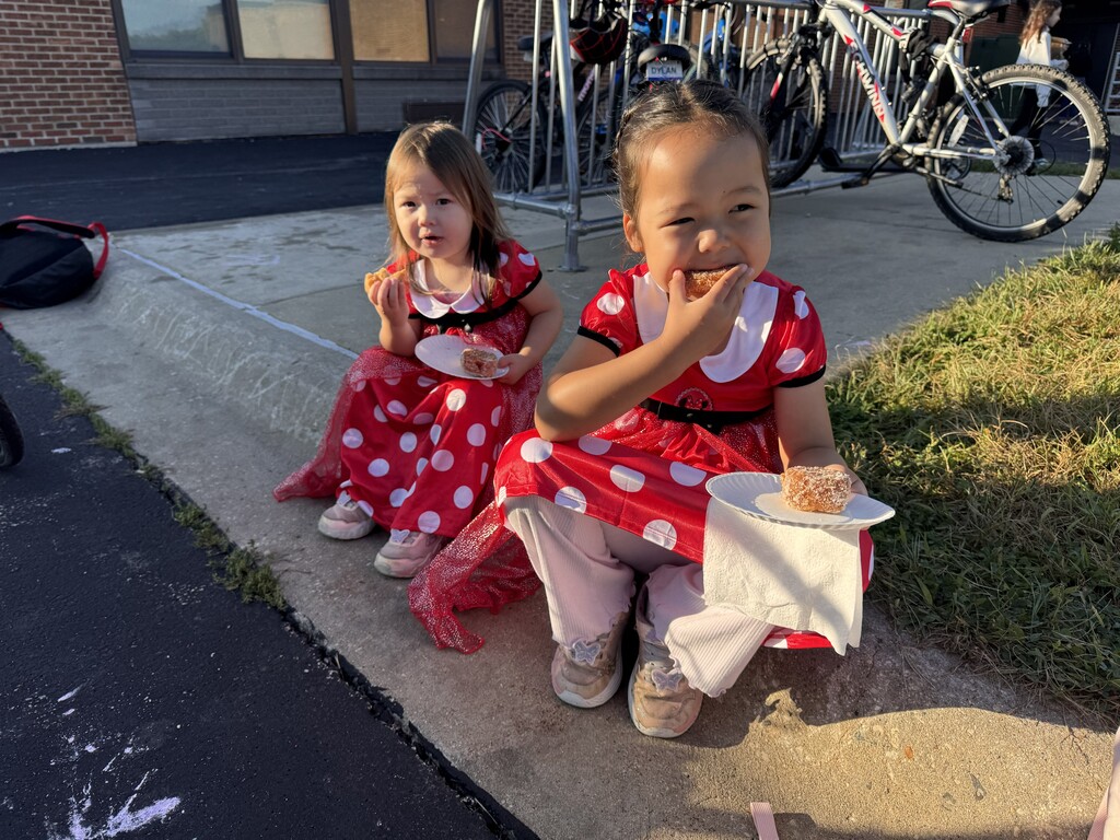2 girls eating donuts