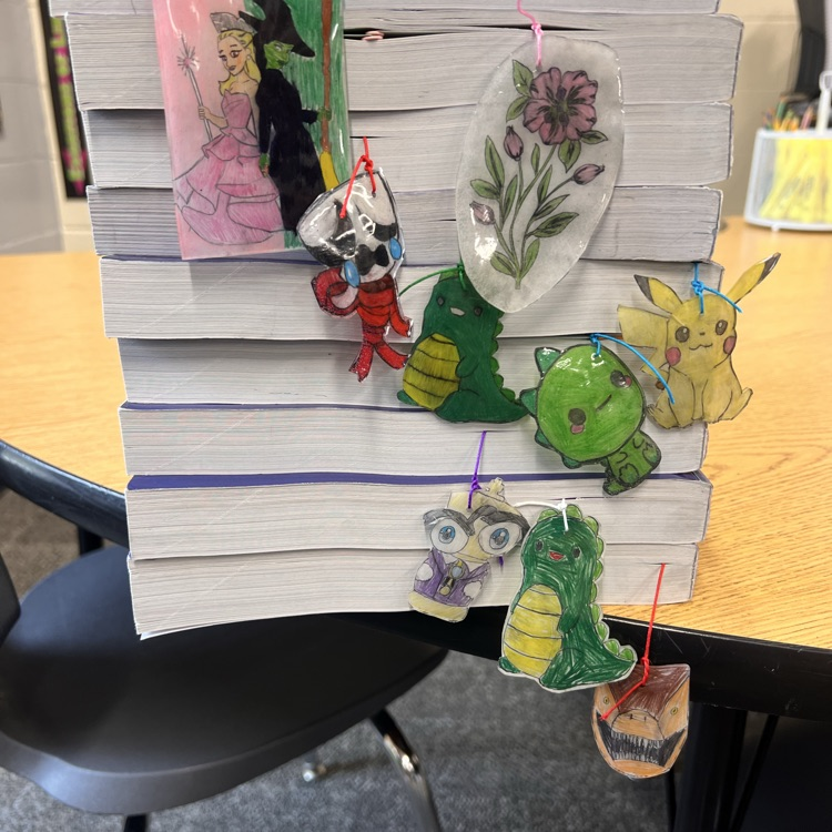 stack of books with shrinky dink book marks