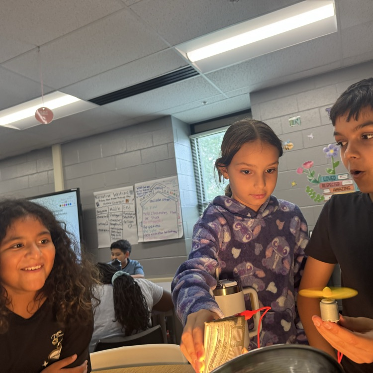 students looking surprised at a circuit working