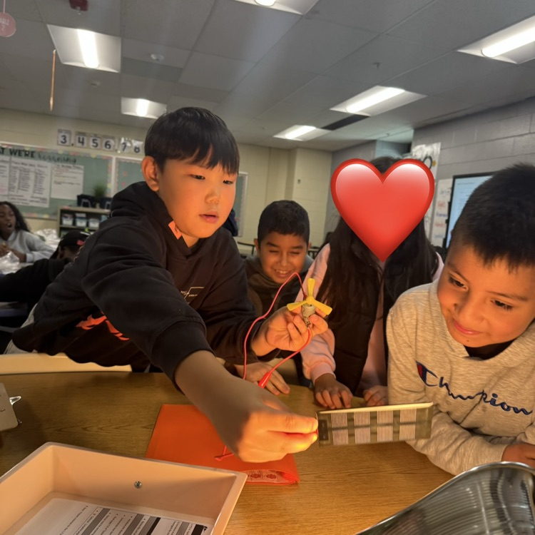 students working together on a simple machine