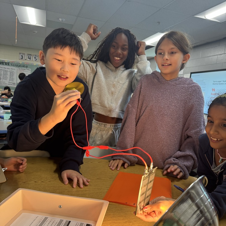 students smiling and celebrating their simple machine