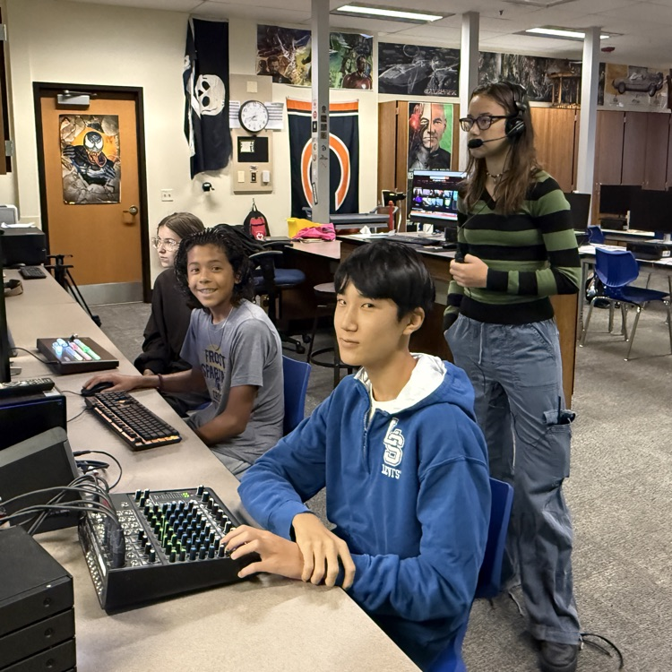 students sitting at a desk with volume controls