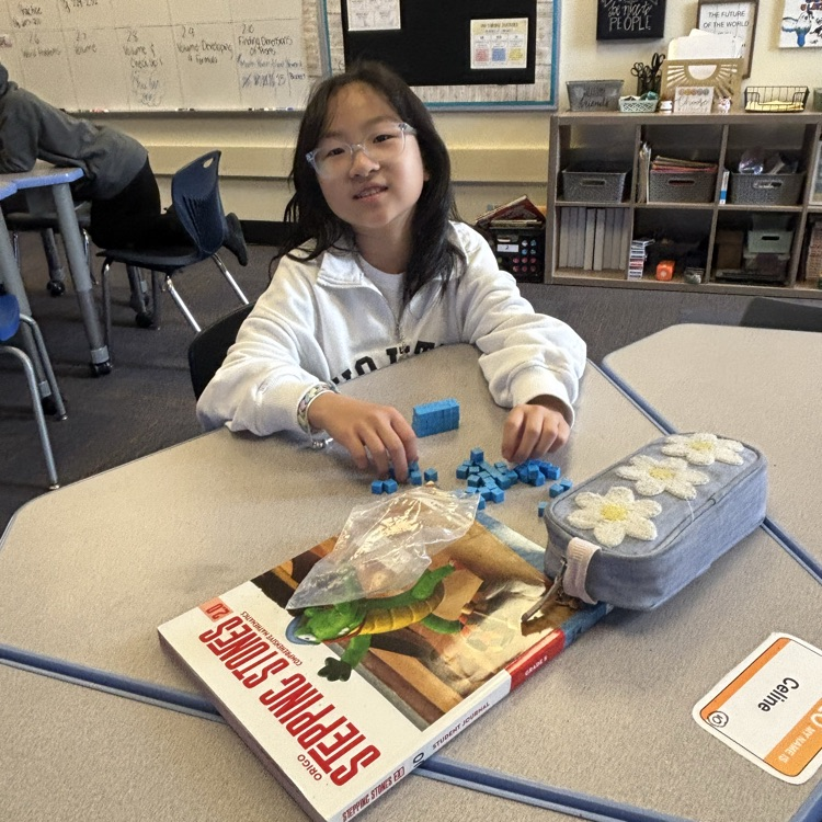 student using base 10 blocks to explore the concept of area